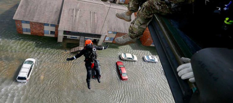 Rescue operation from helicopter in flood zone