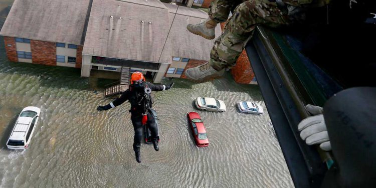 Rescue operation from helicopter in flood zone