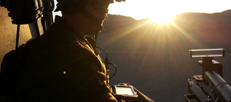 Soldier using smartphone before deployment