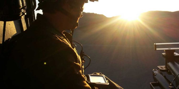 Soldier using smartphone before deployment