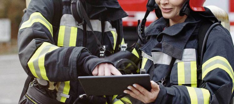 Firefighters looking at tablet